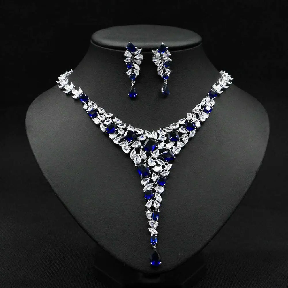 Elegant red crystal leaf zircon necklace set with v-shaped design in silver-toned metal featuring matching earrings