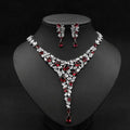 Elegant red crystal leaf zircon necklace set with v-shaped design in silver-toned metal featuring clear crystals