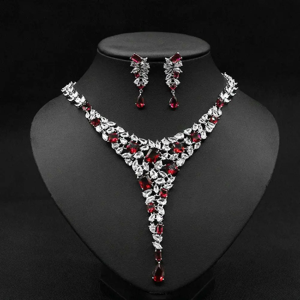 Elegant red crystal leaf zircon necklace set with v-shaped design in silver-toned metal featuring clear crystals
