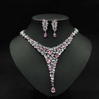 Elegant pink and clear crystal zircon necklace set with v-shaped design featuring square-cut stones and teardrop pendants