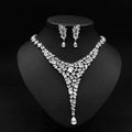 A sparkling silver red crystal leaf zircon necklace set with v-shaped design and matching cubic zirconia drop earrings