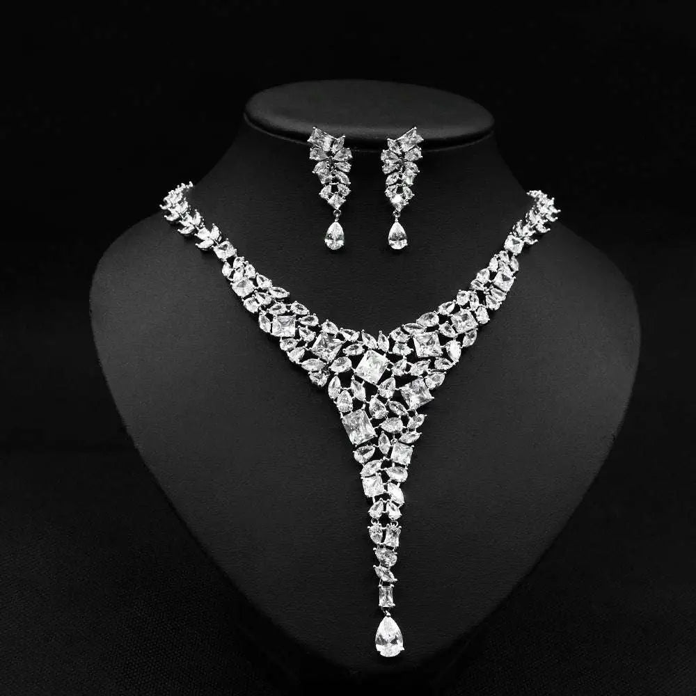 A sparkling silver red crystal leaf zircon necklace set with v-shaped design and matching cubic zirconia drop earrings