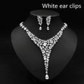 Sparkling silver zircon necklace set with red crystal leaf accents featuring v-shaped design and teardrop pendants
