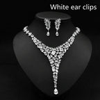 Sparkling silver zircon necklace set with red crystal leaf accents featuring v-shaped design and teardrop pendants