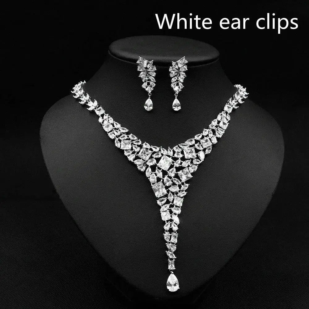 Sparkling silver zircon necklace set with red crystal leaf accents featuring v-shaped design and teardrop pendants