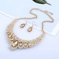 Gold-toned necklace with red crystal teardrop amber crystals and clear rhinestones in an american jewelry fashion design