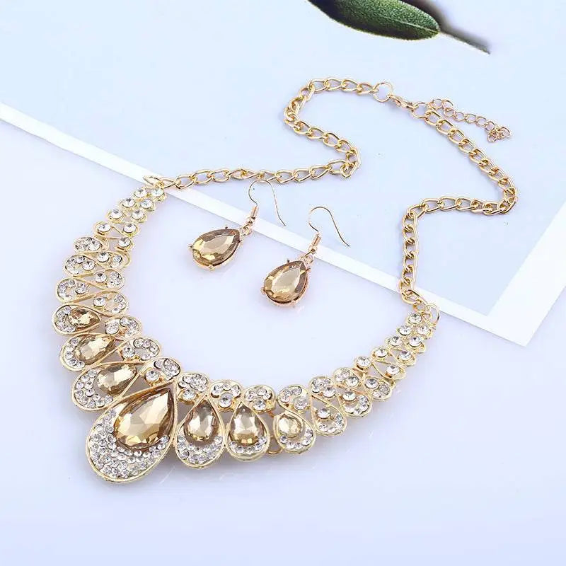 Gold-toned necklace with red crystal teardrop amber crystals and clear rhinestones in an american jewelry fashion design