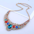 A vibrant gold-toned red crystal teardrop statement necklace with colorful rhinestones in american jewelry fashion