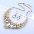Gold-toned necklace with bold layered design featuring large clear crystals in red crystal teardrop american jewelry fashion set