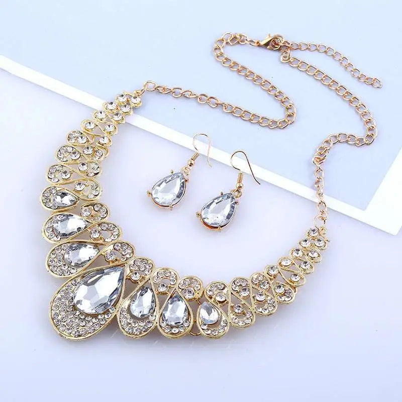 Gold-toned necklace with bold layered design featuring large clear crystals in red crystal teardrop american jewelry fashion set