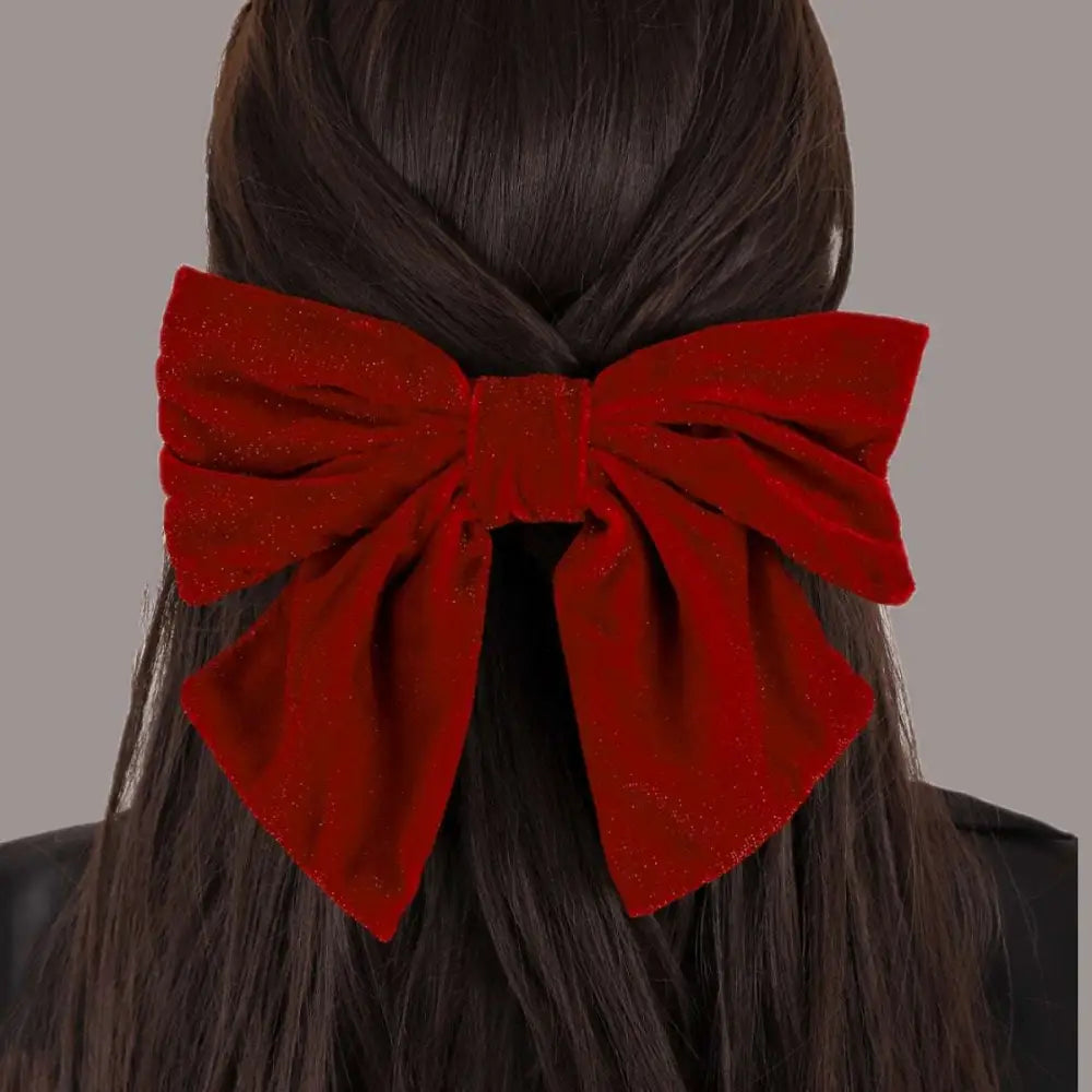 A plush glittery red velvet bow spring clip accessory featuring a red flannel big bow design for stylish wear