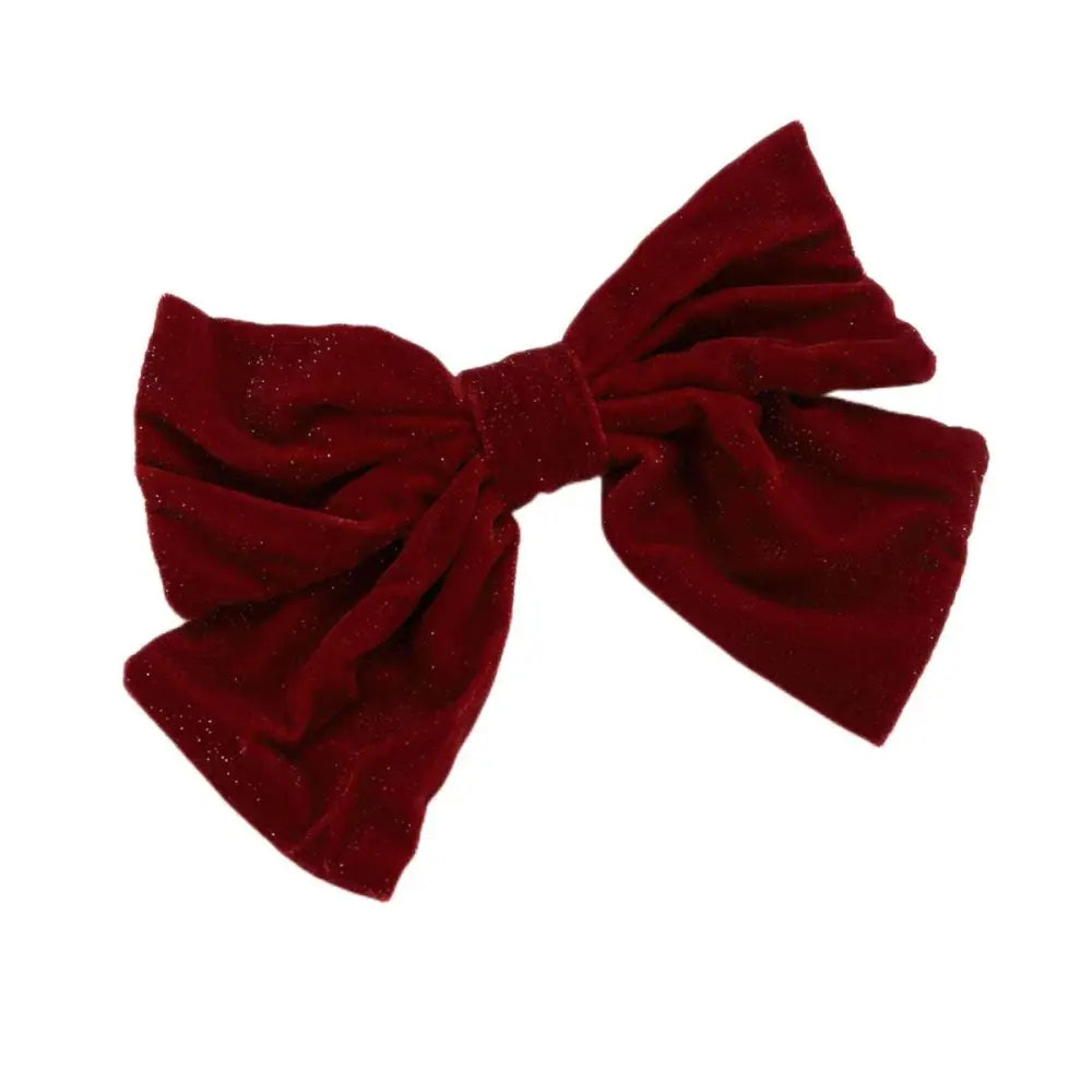 A plush deep red velvet red flannel big bow spring clip accessory with a subtle glittery sheen for spring styling