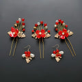 Red floral costume jewelry set with three hairpins featuring gold leaf accents and crystal beads with matching earrings for wedding