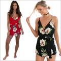 Red floral print jumpsuit image with deep v-neckline, adjustable straps, and matching waist ties in luxury women’s fashion