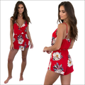 Red floral print jumpsuit with white and gray blossoms on vibrant red fabric perfect for luxury women’s fashion