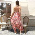 A flowing backless maxi red floral ruffled dress with tiered ruffles showcasing a fashion simple dress style
