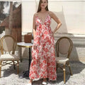 A flowing tiered maxi fashion simple dress in red floral ruffled pattern with thin straps and ruffled neckline