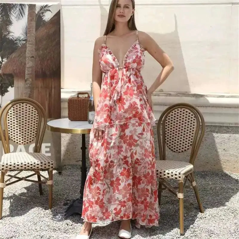 A flowing tiered maxi fashion simple dress in red floral ruffled pattern with thin straps and ruffled neckline