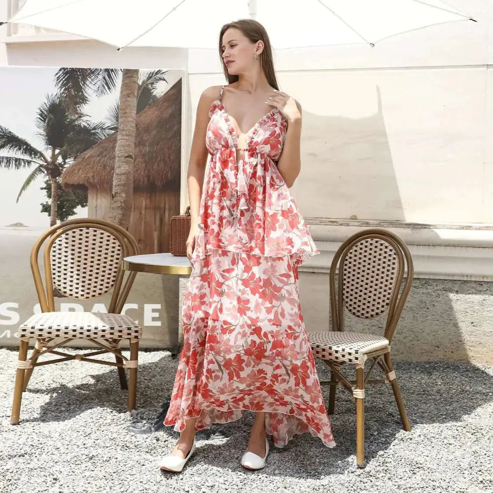 A flowing tiered maxi dress in vibrant coral and white floral print with delicate spaghetti straps red floral ruffled fashion simple dress