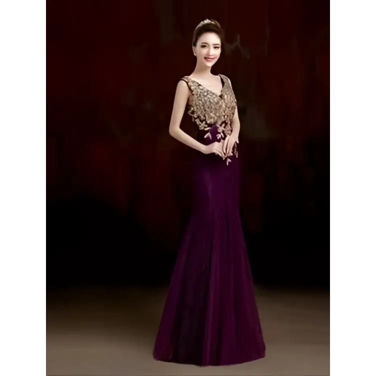 A woman wears an elegant deep purple red gold beaded fish tail banquet evening dress with intricate gold embroidery