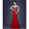 A vibrant red gold beaded fish tail banquet evening dress with intricate embroidery in lace and sheer tulle fabric