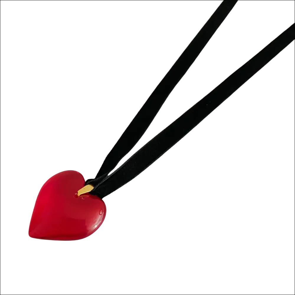 A striking red heart pendant on a black velvet choker black sash necklace in red black sash style
