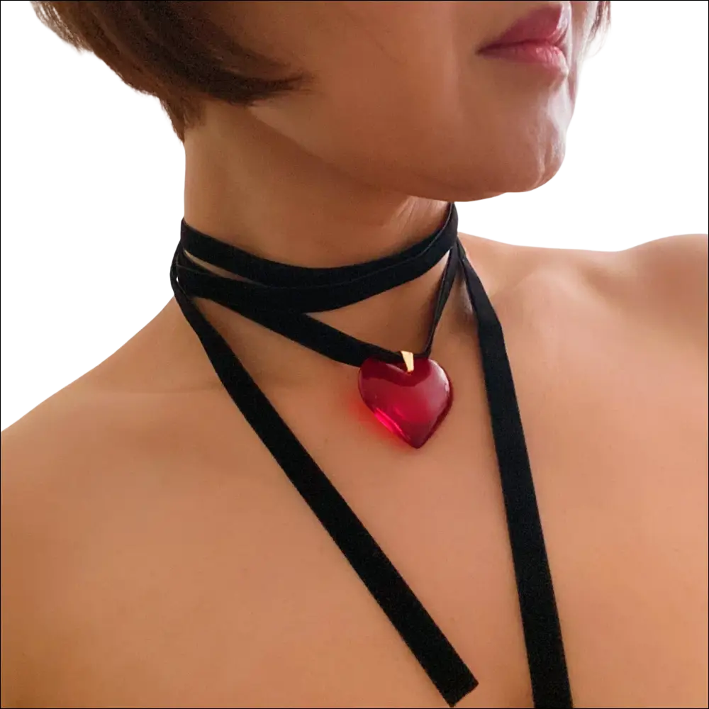 A striking red heart pendant on a black velvet choker black sash necklace in red black sash style
