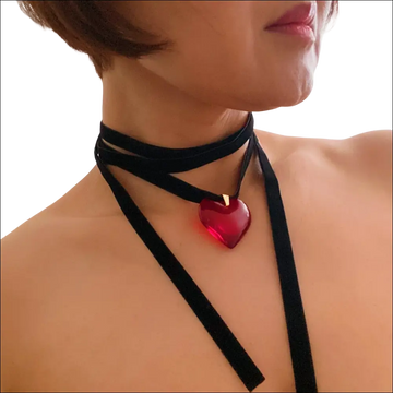 A striking red heart pendant on a black velvet choker black sash necklace in red black sash style
