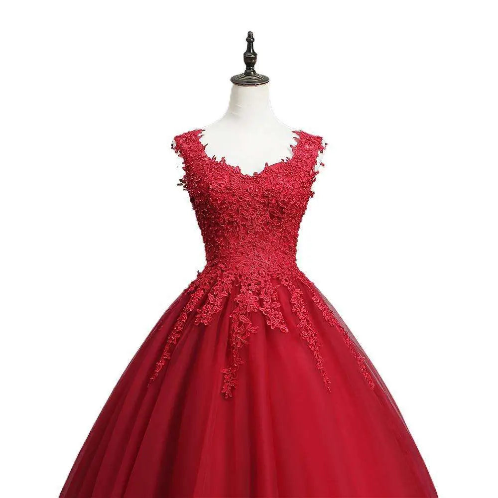 A vibrant red lace bride princess dream tulle gown with intricate lace detailing and a flowing skirt