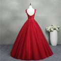 Back view of a red lace bride princess dream tulle gown featuring intricate lace and layered flowing tulle fabric