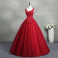 A vibrant red lace bride princess dream tulle gown with intricate lace detailing and a flowing skirt