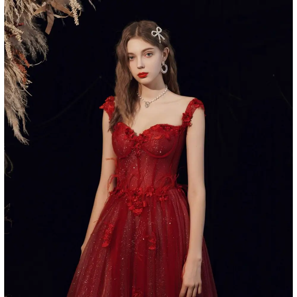 Red lace off shoulder wedding toast dress with shimmering red lace floral appliqués and a sparkling bodice for host annual events