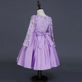 A lavender lace princess dress long sleeve satin skirt with fitted bodice and matching satin bow at the waist