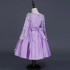 A lavender lace princess dress long sleeve satin skirt with fitted bodice and matching satin bow at the waist