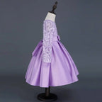 A lavender long sleeve satin princess dress with intricate white lace sleeves and a matching waist bow