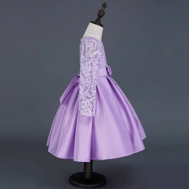 A lavender long sleeve satin princess dress with intricate white lace sleeves and a matching waist bow