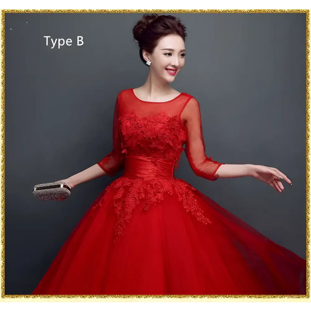 Red lace upscale wedding evening dress with intricate lace detailing three-quarter sheer sleeves and voluminous tulle skirt