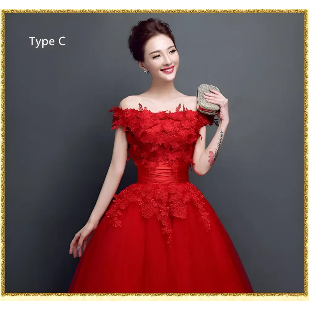 Red lace upscale wedding evening dress featuring intricate lace detailing and a fitted off-the-shoulder bodice