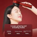 Red handheld scalp care massage device with black bristles for massage activating hair growth and red light scalp therapy