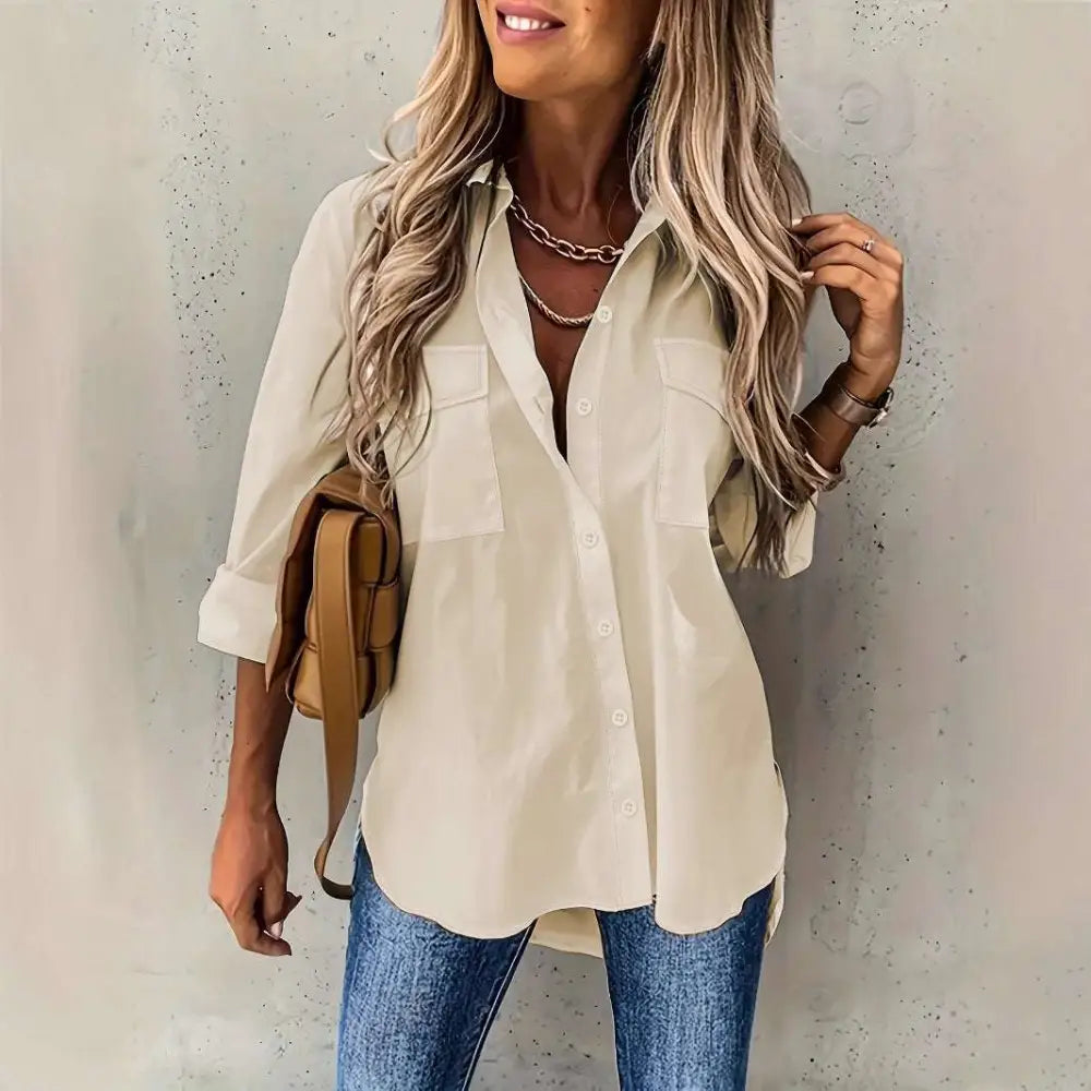 Beige loose long sleeve button up shirt with two chest pockets and sleeve lapel button design with rolled sleeves