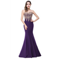 A deep purple red mermaid bride toast gown with intricate gold embroidery on a sheer bodice and thin straps