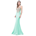 A sleek mint green red mermaid bride toast gown with a sheer bodice and intricate gold beading details