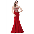 A red mermaid bride toast gown with intricate gold beading and a sheer gold-embellished bodice in sleek satin