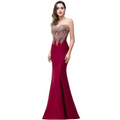 A deep red mermaid bride toast gown with a sweetheart neckline and intricate gold beading on the bodice