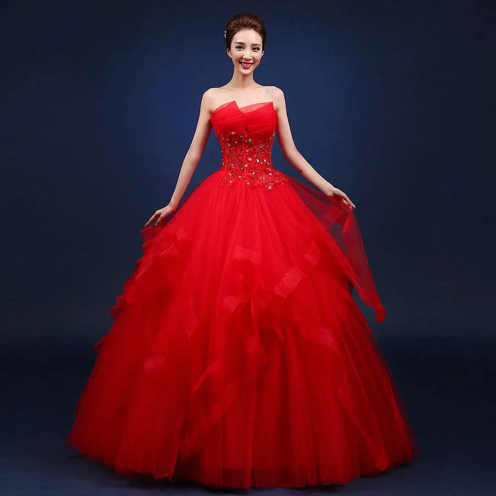 A vibrant red strapless ball gown with sparkling embellishments and a layered tulle skirt for elegant occasions