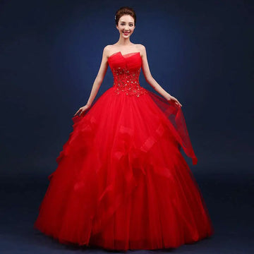 A vibrant red strapless ball gown with sparkling embellishments and a layered tulle skirt for elegant occasions