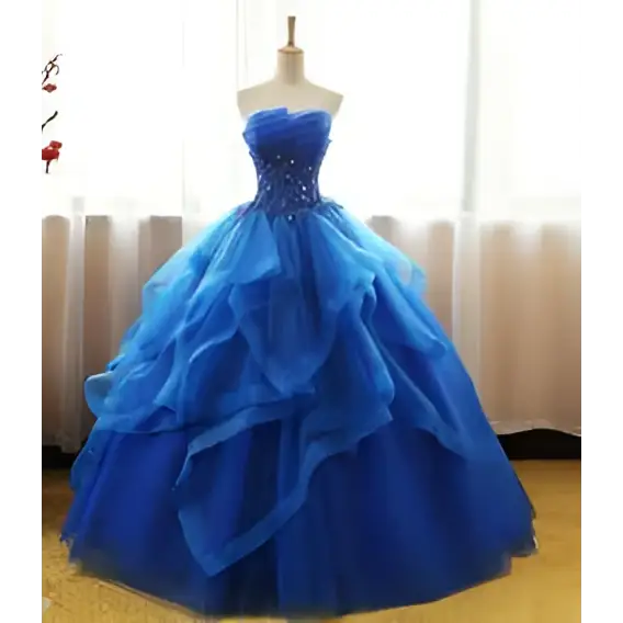 A royal blue strapless ball gown with a beaded bodice and layered tulle skirt in a one-shoulder wedding dress style