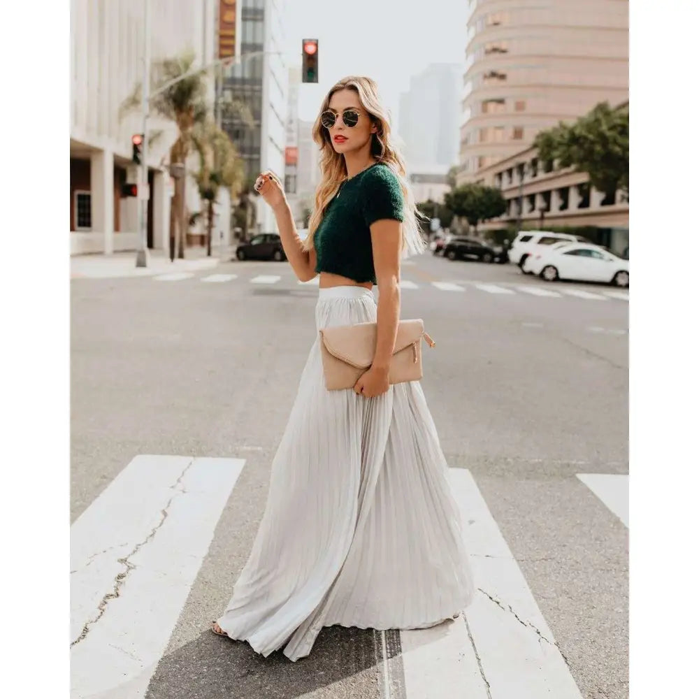 Beige envelope clutch with gold-tone hardware paired with red pleated high waist women fashion casual skirt