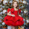 A vibrant red princess dress with a tulle tutu skirt and large satin bow sleeves for special occasions