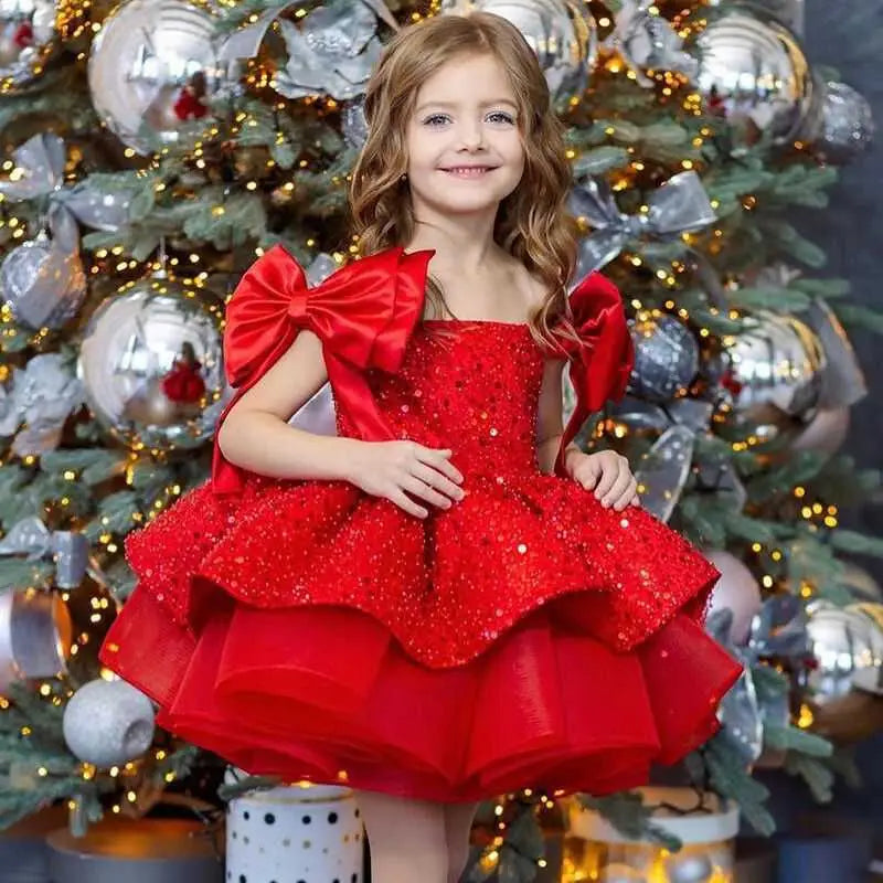 A vibrant red princess dress with a tulle tutu skirt and large satin bow sleeves for special occasions